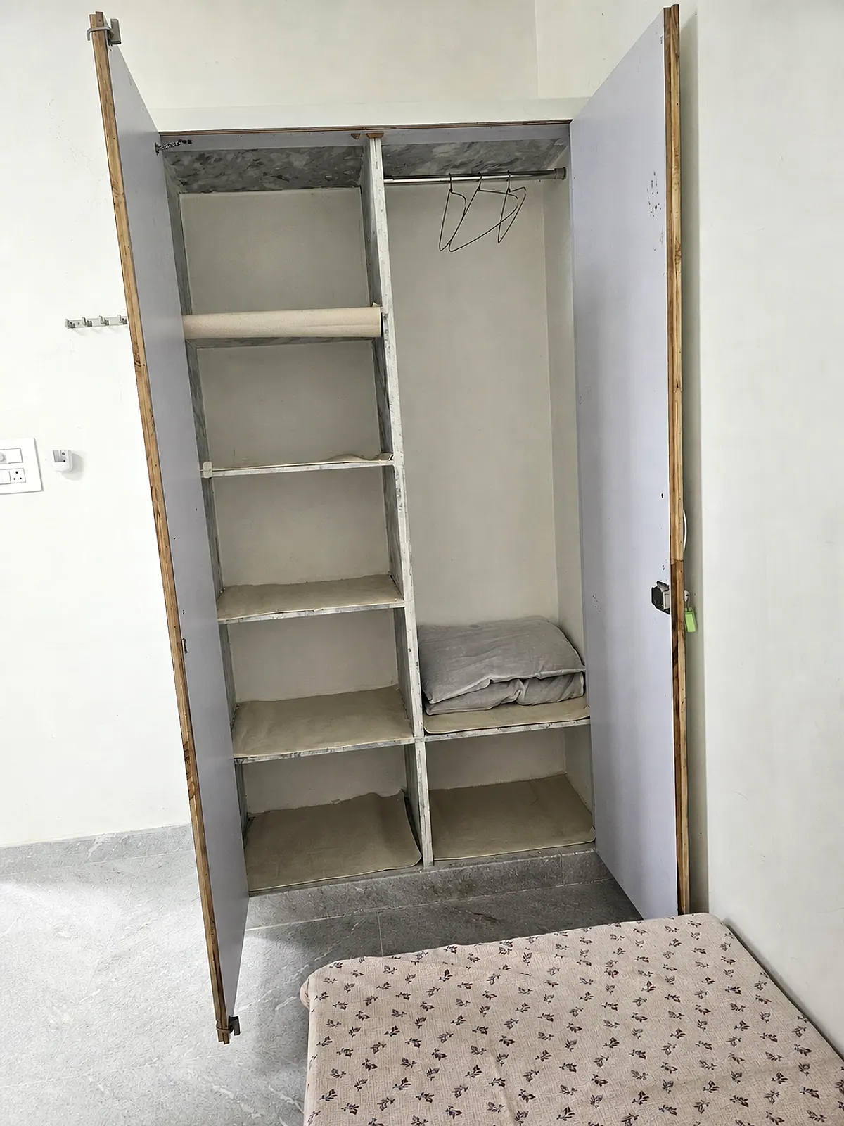 Open wardrobe showing shelves and hanging storage in the representative room